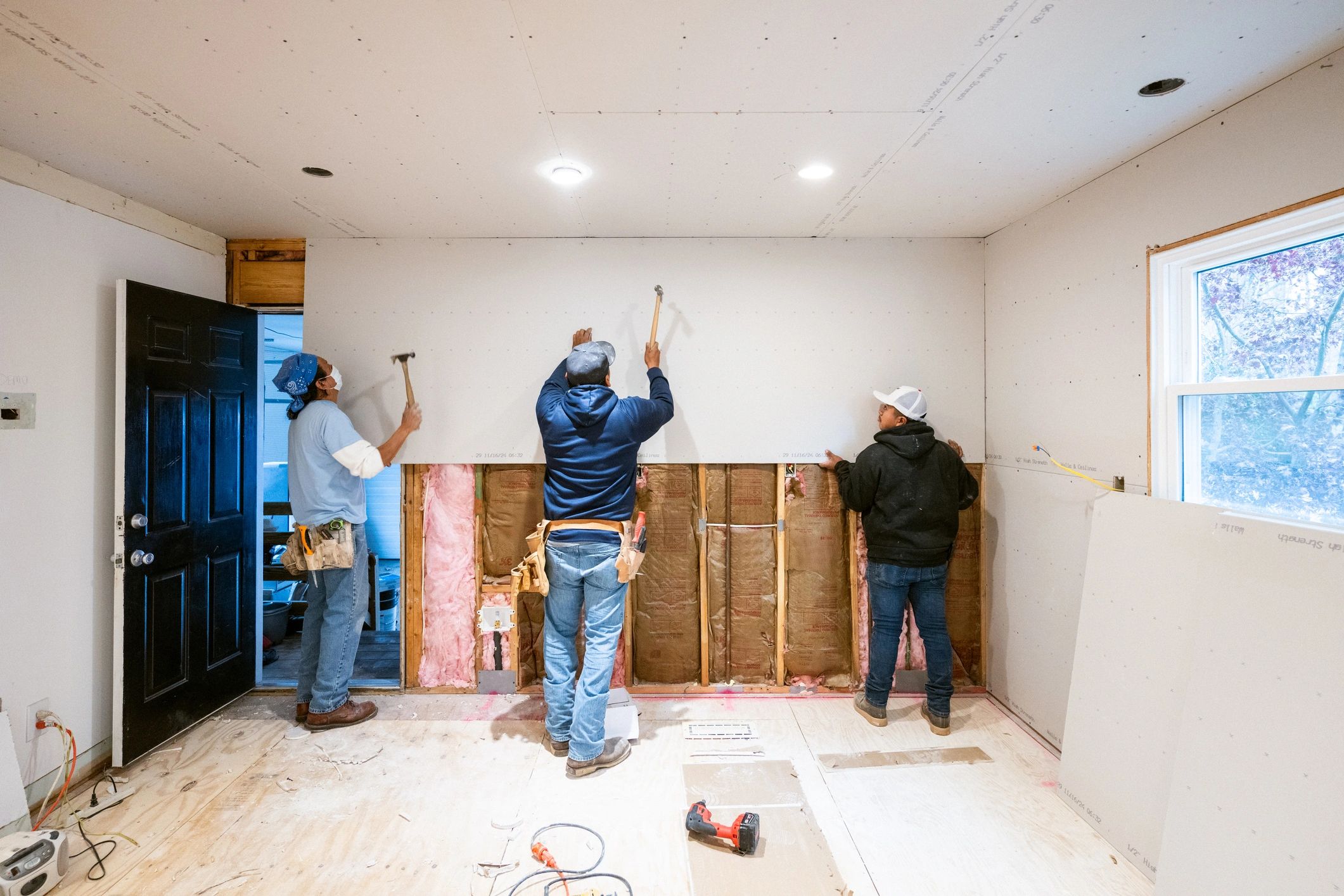 Workers performing renovation work inside a project site